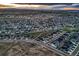 Vast aerial view displaying a community with varied home styles, surrounded by open space and walking paths at 5256 Trails Edge Ln, Castle Rock, CO 80104