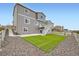 Three-story home showcasing a backyard with a manicured lawn and privacy fence at 5256 Trails Edge Ln, Castle Rock, CO 80104