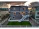 Image of a two-story home's backyard, featuring a patio, stairs, and a small grassy lawn at 5256 Trails Edge Ln, Castle Rock, CO 80104