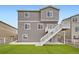 Three-story home showcasing a backyard with a manicured lawn and privacy fence at 5256 Trails Edge Ln, Castle Rock, CO 80104