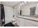 Bathroom with granite countertop, white cabinets, wood-look floor, and tiled shower-tub combo at 5256 Trails Edge Ln, Castle Rock, CO 80104