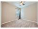 Neutral bedroom with carpet floors, a ceiling fan, and a window providing natural light at 5256 Trails Edge Ln, Castle Rock, CO 80104
