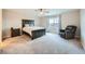 Bedroom with a ceiling fan, carpeted flooring, a dark-wood bed, and an accent chair at 5256 Trails Edge Ln, Castle Rock, CO 80104