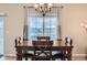 Cozy dining room featuring a wooden table with comfortable seating and a view of the neighborhood through a large window at 5256 Trails Edge Ln, Castle Rock, CO 80104