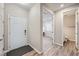 Bright entryway featuring wood flooring, a white front door, and access to a half bathroom at 5256 Trails Edge Ln, Castle Rock, CO 80104