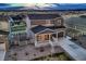 Charming two-story home with a stone facade, a welcoming front porch, and landscaped surroundings at 5256 Trails Edge Ln, Castle Rock, CO 80104