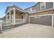 Inviting two-story home with a stone-accented facade, a porch, and a long driveway at 5256 Trails Edge Ln, Castle Rock, CO 80104