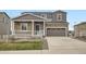 Charming two-story home with a stone facade and inviting front porch at 5256 Trails Edge Ln, Castle Rock, CO 80104