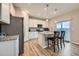Modern kitchen with white cabinets, stainless steel appliances, granite counters and center island with breakfast bar seating at 5256 Trails Edge Ln, Castle Rock, CO 80104