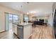 Open-concept kitchen featuring stainless steel appliances, a center island with seating, and seamless flow to the living area at 5256 Trails Edge Ln, Castle Rock, CO 80104