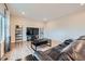 Spacious living room with hardwood floors, a leather couch, and a large TV at 5256 Trails Edge Ln, Castle Rock, CO 80104