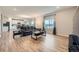 Open-concept living room with hardwood floors, a leather couch, and plenty of natural light at 5256 Trails Edge Ln, Castle Rock, CO 80104