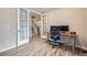 Well-lit office with wood floors, French doors, and modern desk setup, offering a stylish and functional workspace at 5256 Trails Edge Ln, Castle Rock, CO 80104