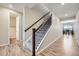 Elegant staircase with carpeted steps and a dark wood railing, leading to the upper level at 5256 Trails Edge Ln, Castle Rock, CO 80104