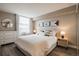 Serene bedroom featuring a large window, neutral tones, and modern furnishings at 1301 Speer Blvd # 309, Denver, CO 80204