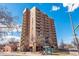 Brick apartment building featuring multiple stories, balconies, and convenient access to public transportation at 1301 Speer Blvd # 309, Denver, CO 80204
