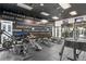 On-site gym with wall art, weight machines, benches and dumbbells at 1301 Speer Blvd # 309, Denver, CO 80204
