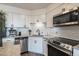 Bright kitchen with stainless steel appliances, white cabinets, and stylish subway tile backsplash at 1301 Speer Blvd # 309, Denver, CO 80204