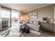Elegant living room features a sliding glass door with balcony access and comfortable seating and decor at 1301 Speer Blvd # 309, Denver, CO 80204