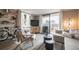 Cozy living room featuring a sliding glass door with a balcony, neutral decor, and comfortable seating at 1301 Speer Blvd # 309, Denver, CO 80204
