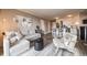 Open-concept living room seamlessly flows into a modern kitchen with bar seating at 1301 Speer Blvd # 309, Denver, CO 80204