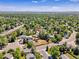 Drone shot of property featuring mature trees, professional landscaping, and neighborhood views at 655 Gooseberry Ct, Lafayette, CO 80026