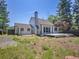 Exterior shot of a white home with a red brick chimney and well maintained backyard at 655 Gooseberry Ct, Lafayette, CO 80026