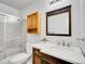 Well-lit bathroom featuring a vanity, framed mirror, toilet, and shower with glass door enclosure at 655 Gooseberry Ct, Lafayette, CO 80026