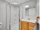 Clean bathroom with a glass shower enclosure, modern vanity, and neutral finishes at 655 Gooseberry Ct, Lafayette, CO 80026