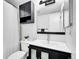 Well-lit bathroom with a vanity, toilet, and shower featuring a shower curtain at 655 Gooseberry Ct, Lafayette, CO 80026