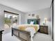 Bright bedroom featuring a large window with neighborhood views, a queen-size bed, and a nightstand at 655 Gooseberry Ct, Lafayette, CO 80026