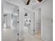 Bright hallway with multiple open doorways leading to other rooms with neutral paint and flooring at 655 Gooseberry Ct, Lafayette, CO 80026