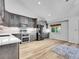 Bright kitchen with stainless appliances, gray cabinetry, light countertops and wood floors at 655 Gooseberry Ct, Lafayette, CO 80026