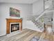 Cozy living room featuring a fireplace, hardwood floors, and stairs leading to the second floor at 655 Gooseberry Ct, Lafayette, CO 80026
