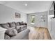 Comfortable living room with a large sectional sofa, wood flooring, and natural light at 655 Gooseberry Ct, Lafayette, CO 80026