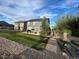 Well-manicured backyard featuring green lawn, gravel, privacy fence, and a cozy patio area at 12901 Crane River Dr, Longmont, CO 80504