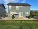 Backyard view with lush green lawn, patio with seating, and privacy fence, creating a serene outdoor retreat at 12901 Crane River Dr, Longmont, CO 80504