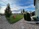 Spacious backyard featuring a lush green lawn, a slide, and a cozy patio area for outdoor relaxation at 12901 Crane River Dr, Longmont, CO 80504