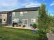 Lush backyard with an outdoor patio, slide, and well-maintained lawn, perfect for relaxation and play at 12901 Crane River Dr, Longmont, CO 80504