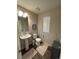 Cozy bathroom featuring a pedestal sink, toilet, neutral colors and soft lighting at 12901 Crane River Dr, Longmont, CO 80504