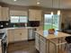 Open kitchen with white cabinets, stainless steel appliances and a view of the backyard at 12901 Crane River Dr, Longmont, CO 80504