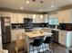 Modern kitchen features white cabinets, a kitchen island and stainless steel appliances at 12901 Crane River Dr, Longmont, CO 80504