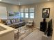 Cozy living room offers natural light, comfortable seating, and a stylish rug, perfect for relaxation at 12901 Crane River Dr, Longmont, CO 80504