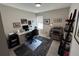 Carpeted office with a desk, black chair, printer, shelving, computer, and a window at 12901 Crane River Dr, Longmont, CO 80504