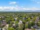 Extensive aerial view of a community surrounded by lush greenery and mountain views at 10978 Roseanna Dr, Northglenn, CO 80234