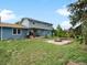 Large backyard with a blue two-story home in the background and landscaped fire pit at 10978 Roseanna Dr, Northglenn, CO 80234