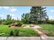 Landscaped backyard featuring a fire pit, and grassy area at 10978 Roseanna Dr, Northglenn, CO 80234