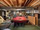 Unfinished basement area featuring a pool table, storage shelves, and comfortable seating at 10978 Roseanna Dr, Northglenn, CO 80234