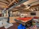 Unfinished basement featuring a pool table and bar with exposed ceiling and ductwork at 10978 Roseanna Dr, Northglenn, CO 80234