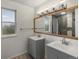 Bright bathroom featuring double sinks and a large, modern vanity at 10978 Roseanna Dr, Northglenn, CO 80234